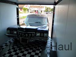 Our Caddy hearse being loaded into our enclosed trailer.