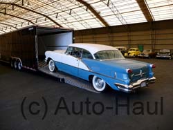 Oldsmobile being loaded to go to a very lucky owner.